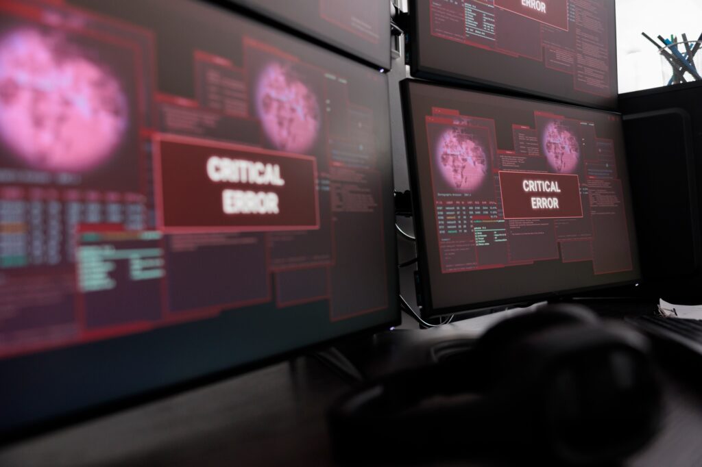 Close up of multiple monitors having critical error message on display