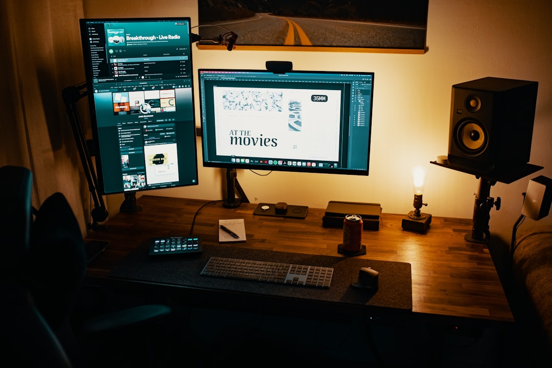 black flat screen computer monitor on brown wooden desk